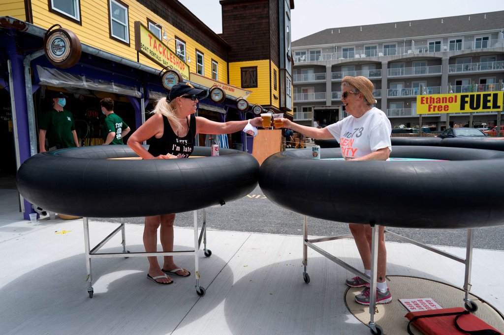 People try out social-distancing 'bumper tables' as the Fish Tales restaurant opened for in-person dining in Ocean City, Maryland, on May 29.Alex Edelma-AFP-Getty Images.jpg