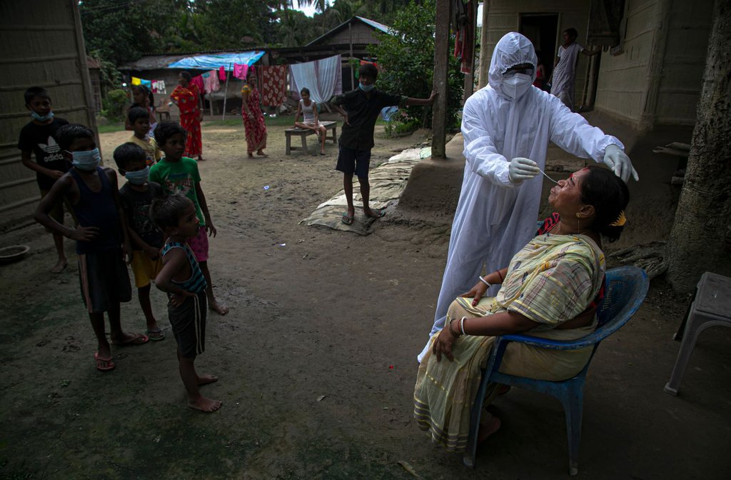 A health worker administers a Covid-19 test in the Indian village of Kusumpur on Monday, August 17.Anupam Nath-AP.jpg