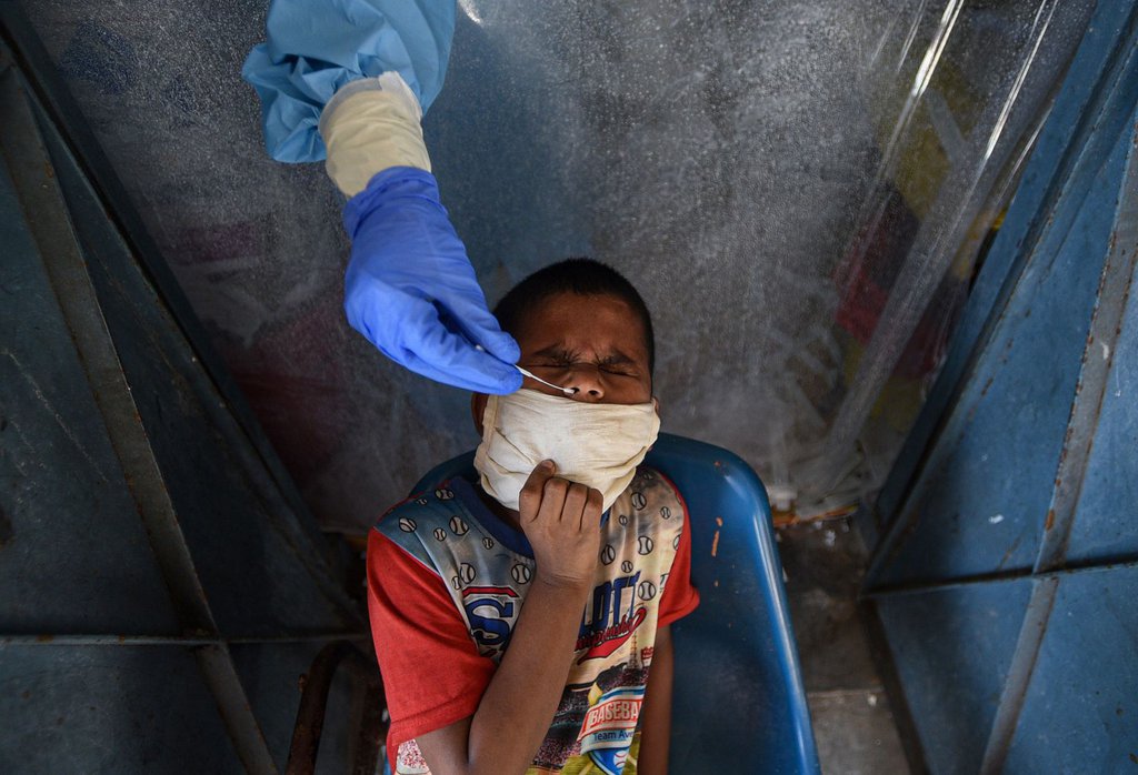 A health worker tests a child for Covid-19 at a school in New Delhi on July 27.Biplov Bhuyan-HindustanTimes-Getty Images.jpg