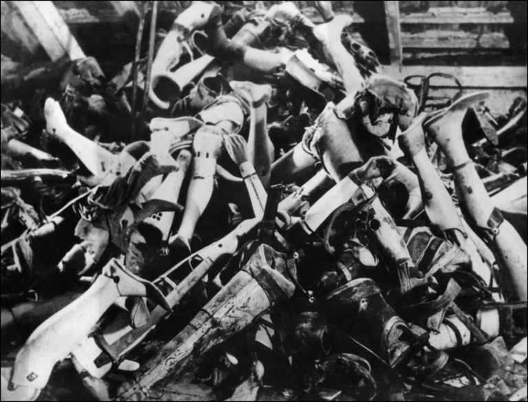 A pile of prostheses belonging to the murdered victims of the Auschwitz concentration camp in Poland following its liberation, January 1945..jpg