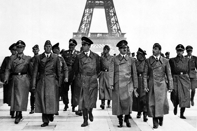 Adolf Hitler and his entourage walk near the Eiffel Tower in Paris on June 23, 1940, following the occupation of France by the Nazis..jpg