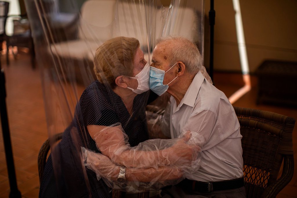 Agustina Cañamero and Pascual Pérez kiss each other through a plastic screen at a nursing home in Barcelona, Spain, on June 22. They've been married for 59 years.Emilio Morenatti-AP.jpg