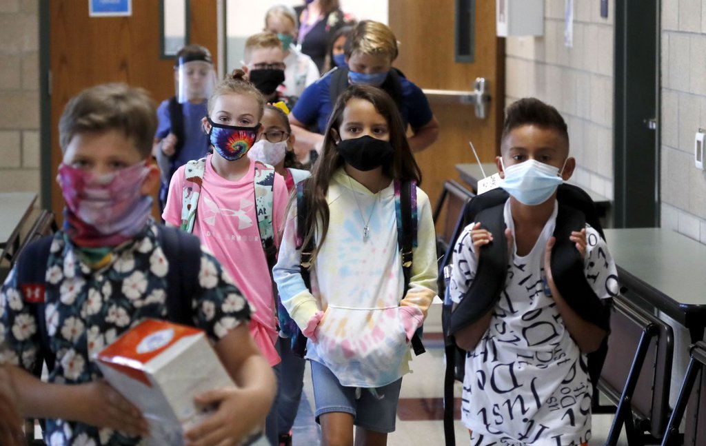 Elementary school students walk to class in Godley, Texas, on August 5. Three rural school districts in Johnson County were among the first in the state to head back to school for in-person classes.LM Otero-AP.jpg