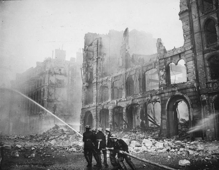 Firefighters put out a blaze caused by a round of German bombings in London, 1941..jpg