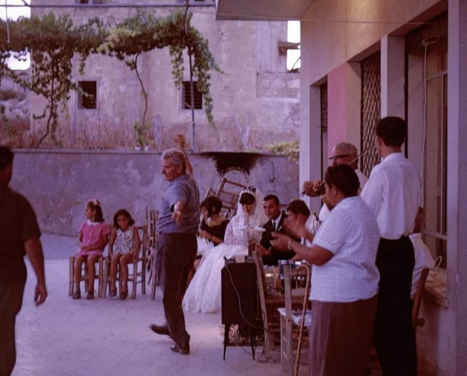 Georgo's wedding reception in the cafe in Koma. Papou Nicos is playing Violin. The woman in the foreground in Kakou tou Strouphou. She sang like a bird and operated a taxi from Koma to Famagusta..jpg