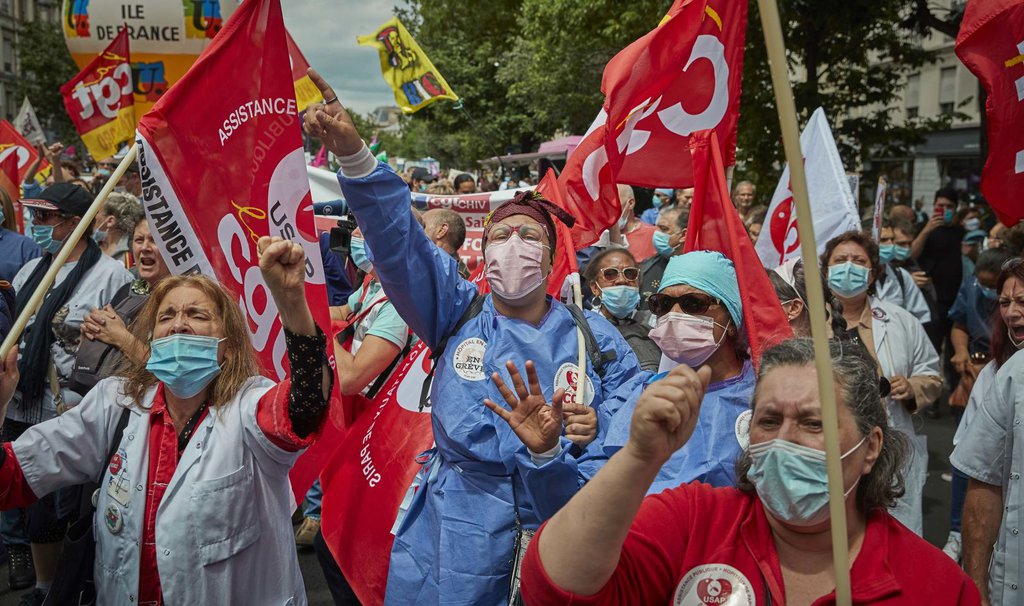 Health-care workers and union members demonstrate during a Bastille Day protest in Paris on July 14. France is giving health-care workers a raise for their efforts to fight the novel coronavirus.Kiran Ridley-Getty Images.jpg