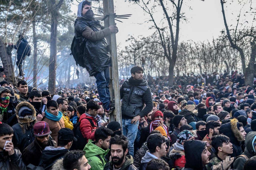 People in Pazarkule gather inside a buffer zone at the border on Saturday, February 29.Bulent Kilic AFP.jpg