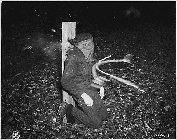 Photo taken at the instant that bullets from a French firing squad hit a French man who had collaborated with the Germans in Rennes, France on November 21, 1944..jpg