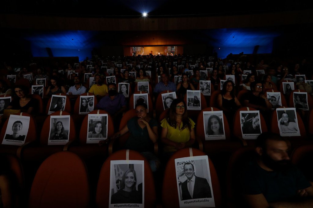 Portraits are taped onto seats to help theatergoers spread out in Nicosia, Cyprus, on July 27.Petros Karadjias-AP.jpg