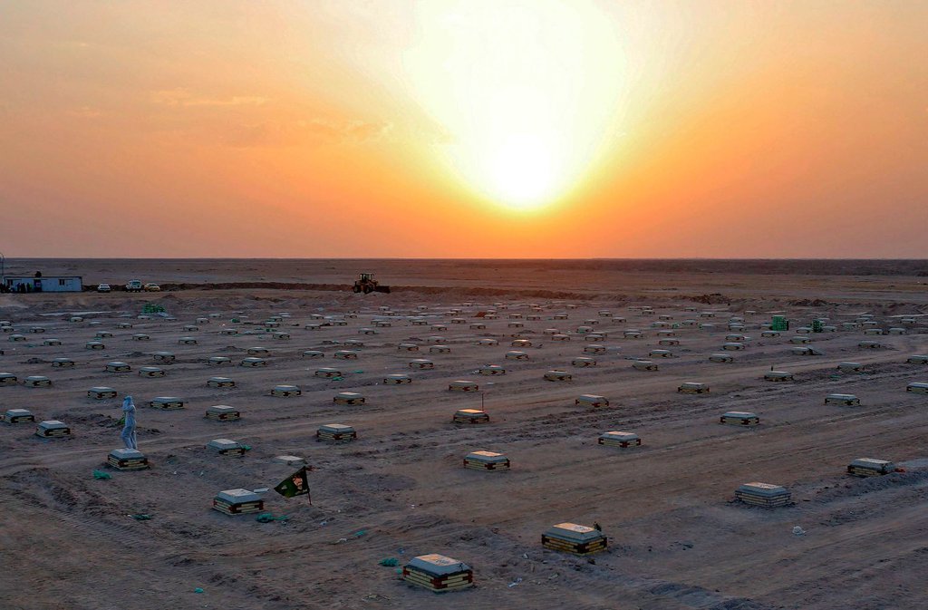 The sun sets over a cemetery for coronavirus victims near Najaf, Iraq, on June 10.Ali Najafi-AFP-Getty Images.jpg