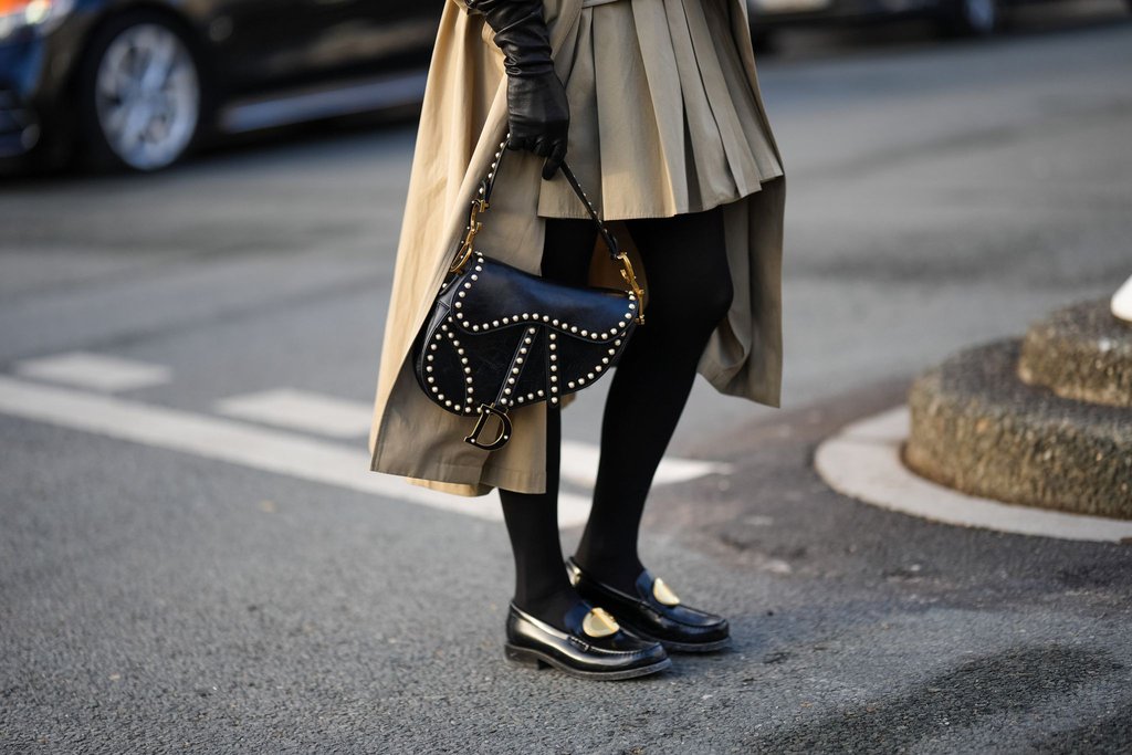 guest-wears-a-black-leather-dior-saddle-bag-black-shoes-a-news-photo-1707406142.jpg