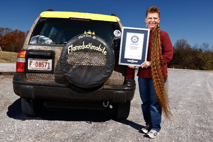 tami-manis-alongside-her-car-and-holding-her-gwr-certificate_tcm25-757651.jpg